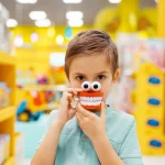 boy with fake teeth and eyes toy