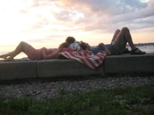 people lying on their backs, sunset