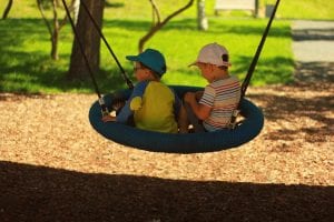 children on a tire swing