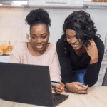 Young Black women using a computer together