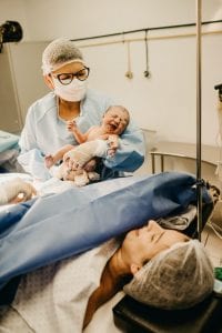 couple in a surgical suite after a cesarean section delivery