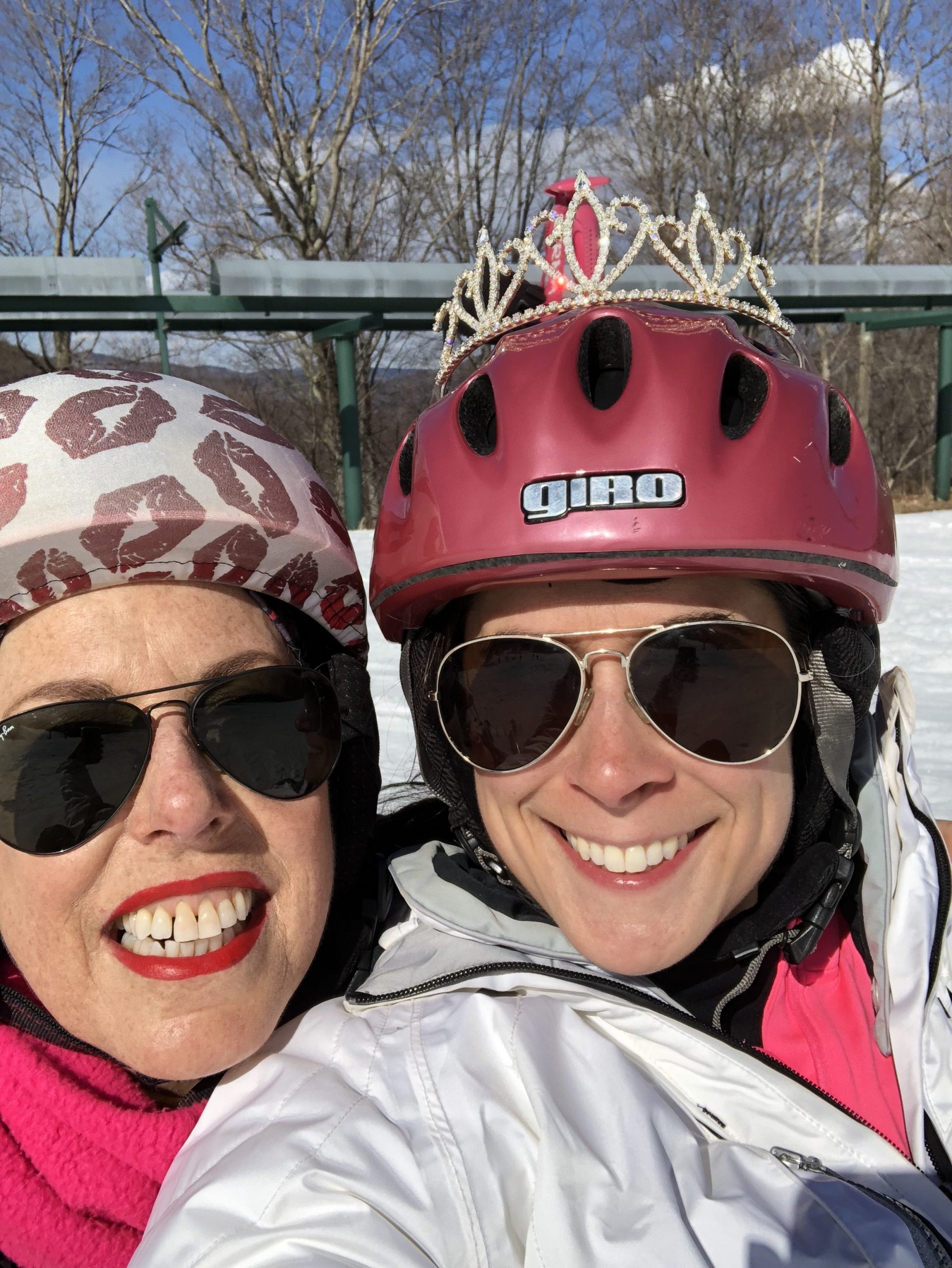 Mother an daughter selfie, wearing a tiera and ski helmets