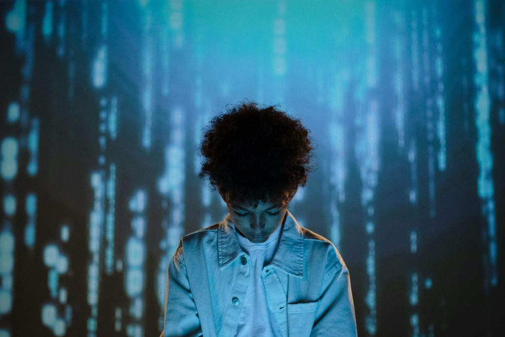 boy looking down with a blue digital-looking background