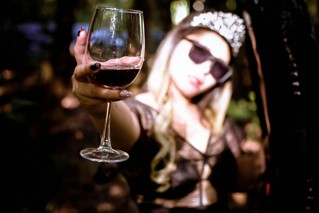 mom raises a glass of red wine 