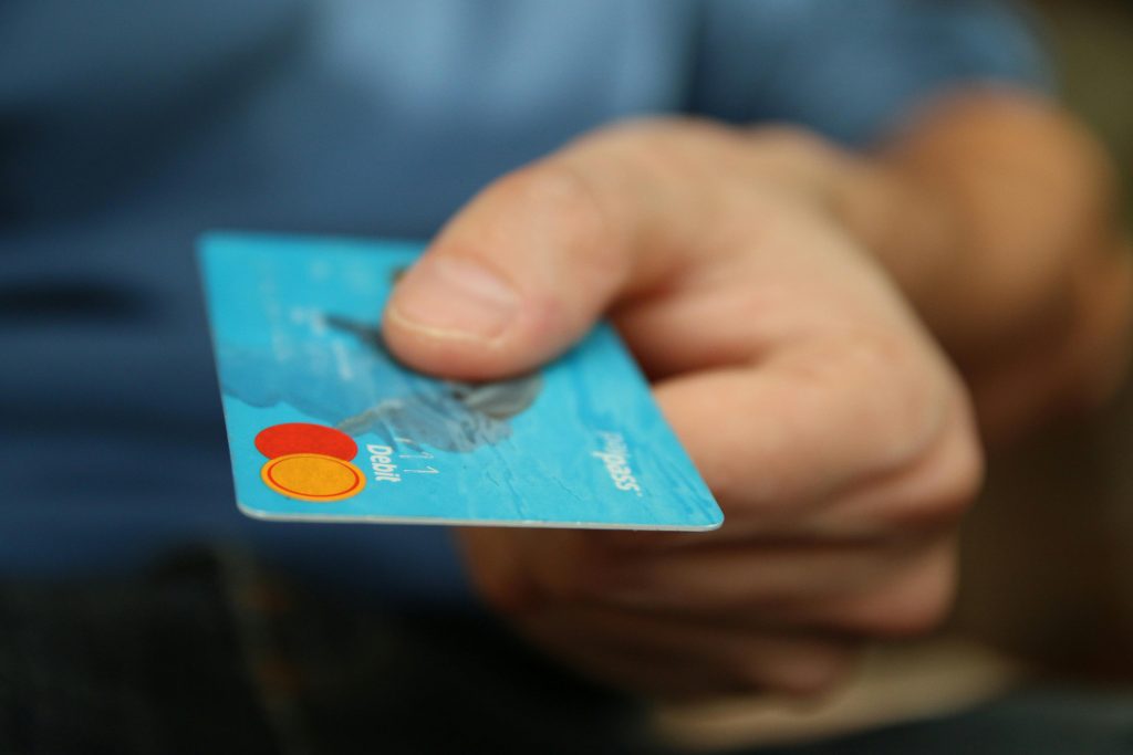 teen hand holding a debit card