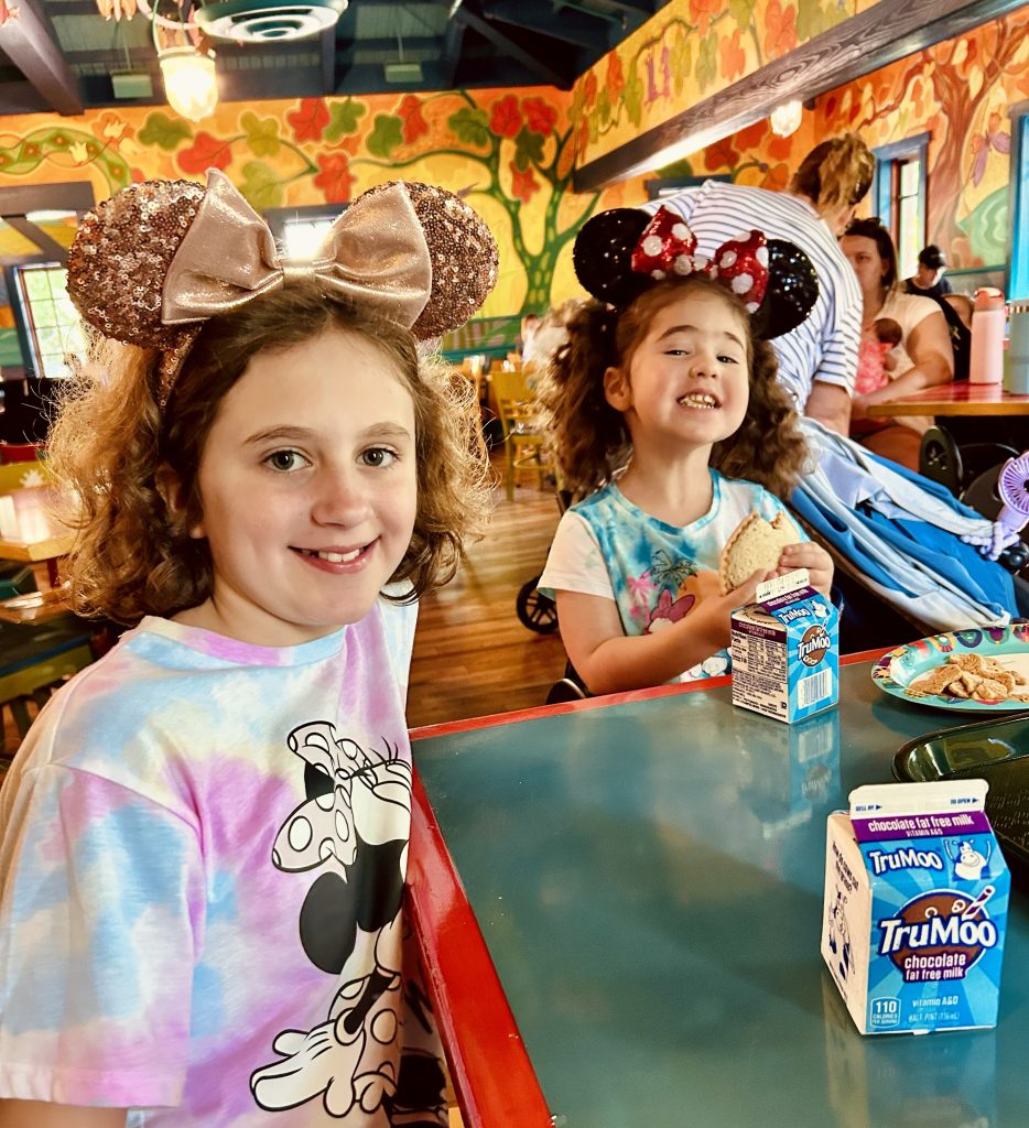 Two little girls with chocolate milk at lunch
