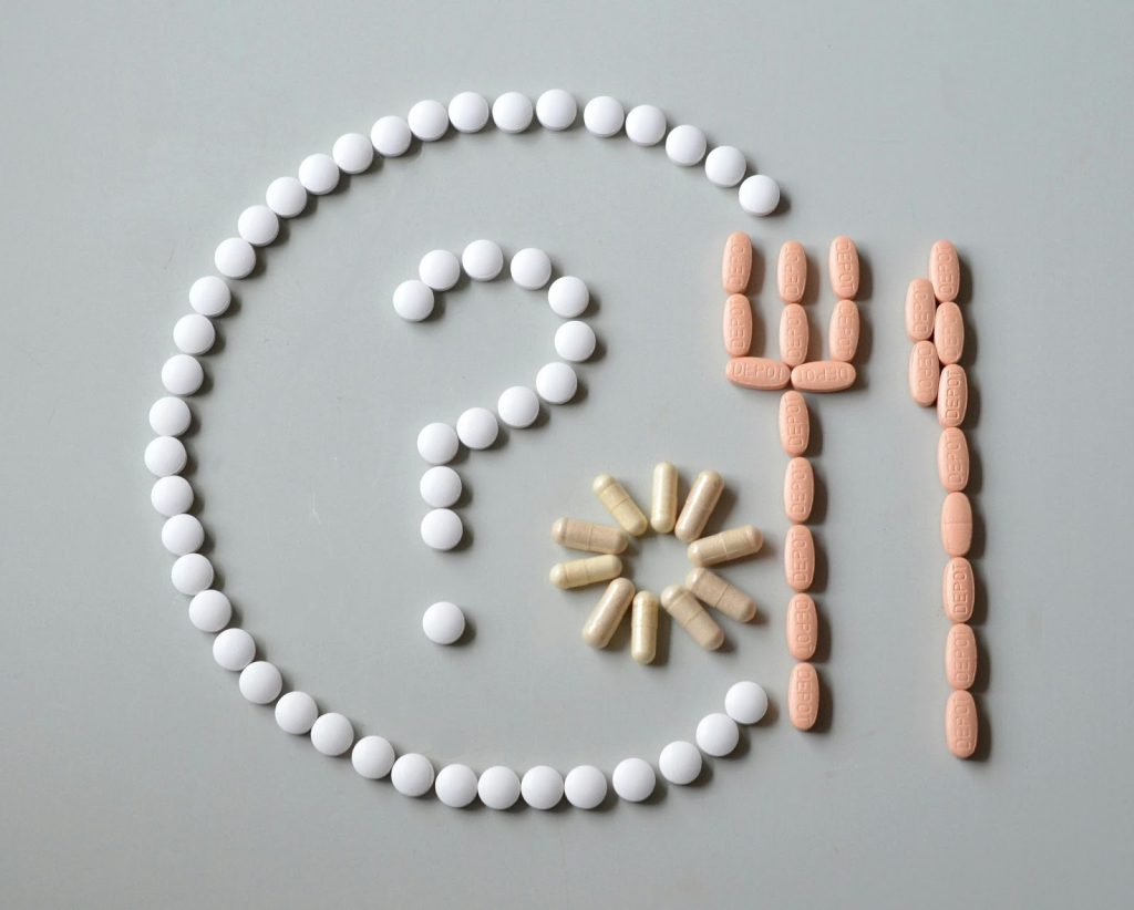 pills laid out in a pattern including a question mark