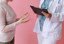 I’ve Got 99 Problems and Perimenopause is All of Them Doctor holding a clipboard talking to a woman