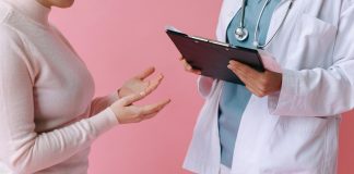 I’ve Got 99 Problems and Perimenopause is All of Them Doctor holding a clipboard talking to a woman