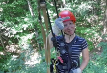 Building Confidence in Myself Outside of Motherhood woman on a zipline, smiling and wearing a red helmet