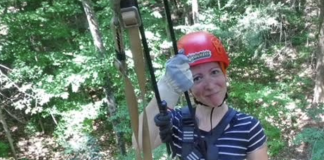 Building Confidence in Myself Outside of Motherhood woman on a zipline, smiling and wearing a red helmet
