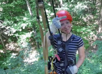 Building Confidence in Myself Outside of Motherhood woman on a zipline, smiling and wearing a red helmet